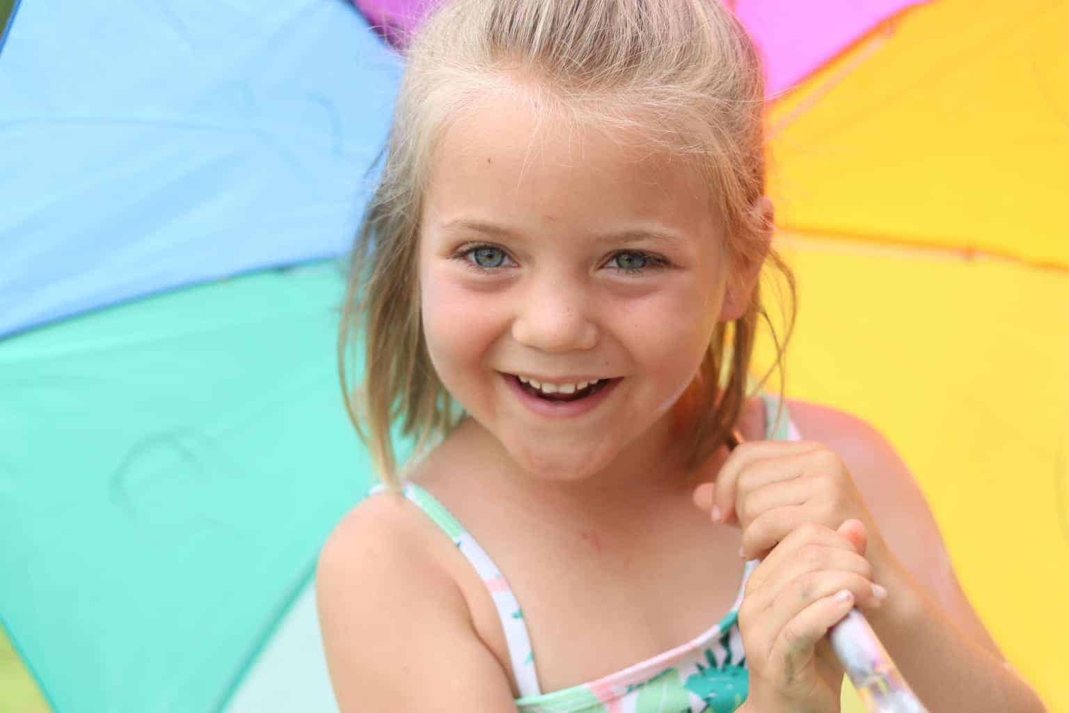Little girl holding a sun umbrella. 